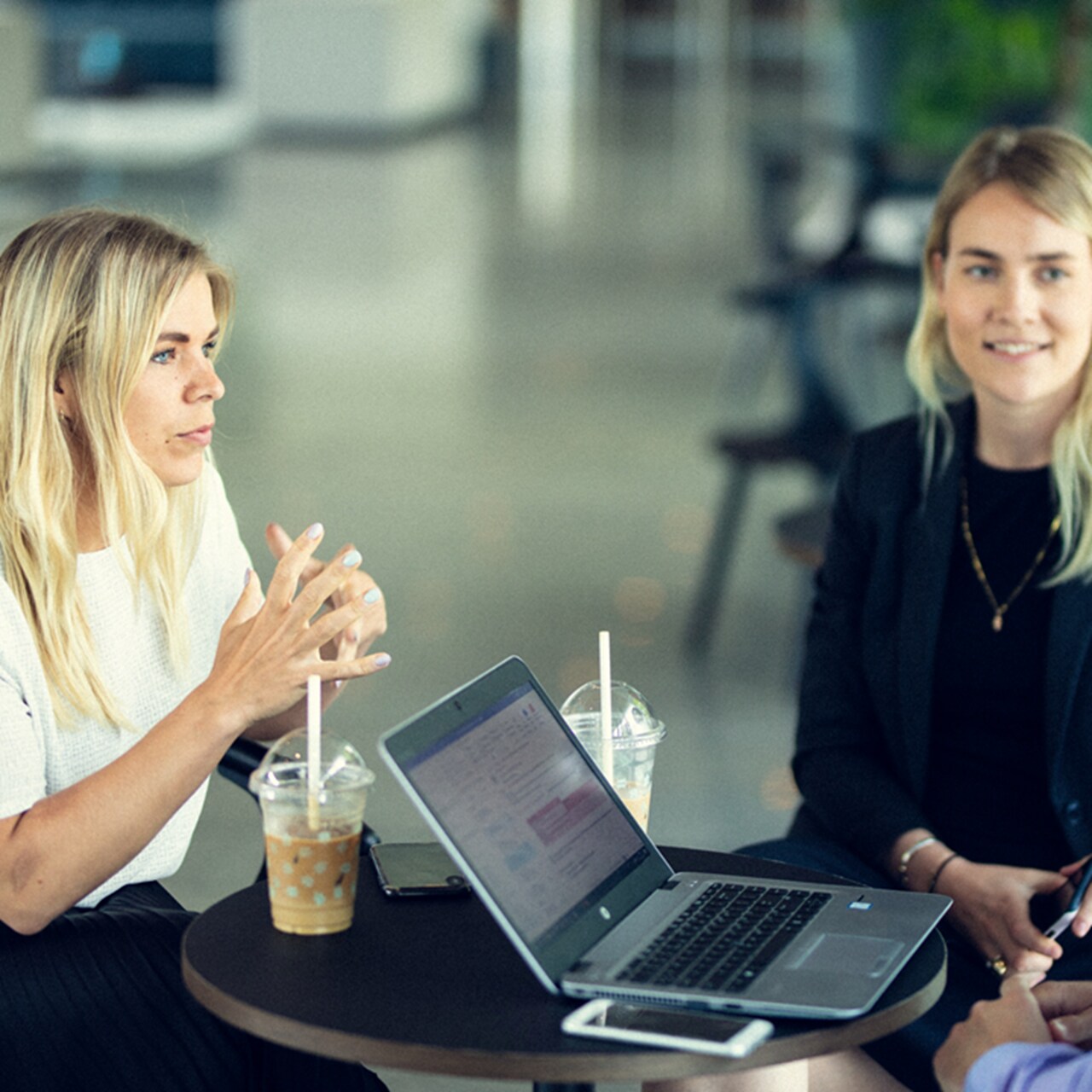 Two female employees are conversing