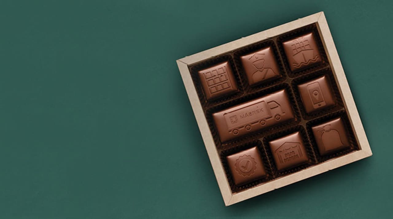Maersk’s integrated logistics solutions across ocean and land engraved on chocolate placed in a box.