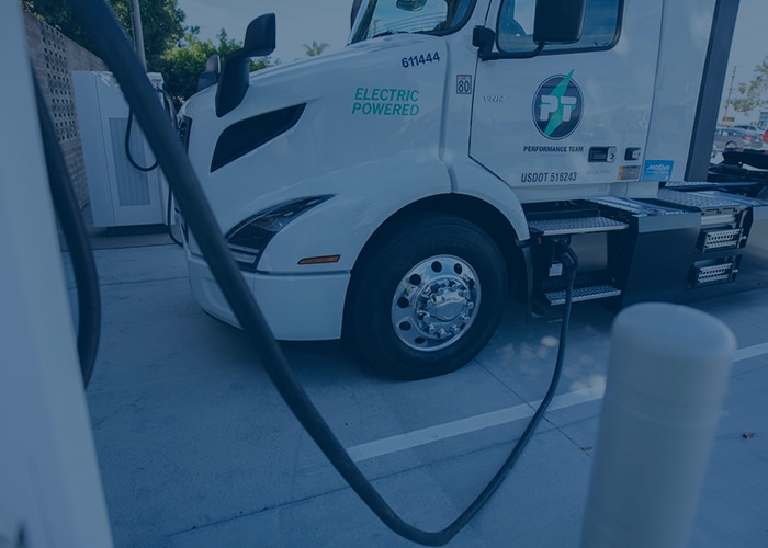 Performance Team Electric truck at Santa Fe Springs warehouse in california parked and charging.
