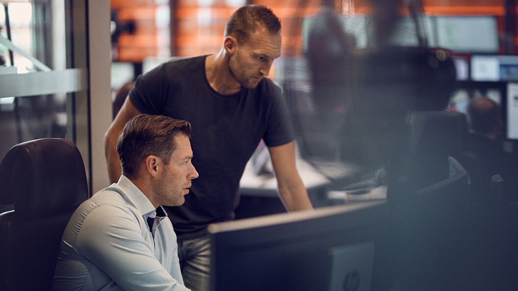 Two Maersk employees looking at a computer screen