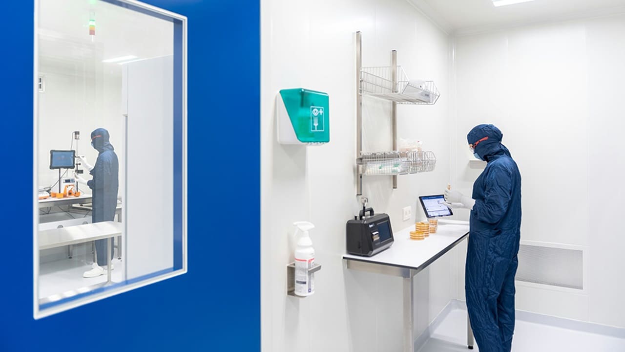 Laboratory technician inspecting environmental monitoring plate