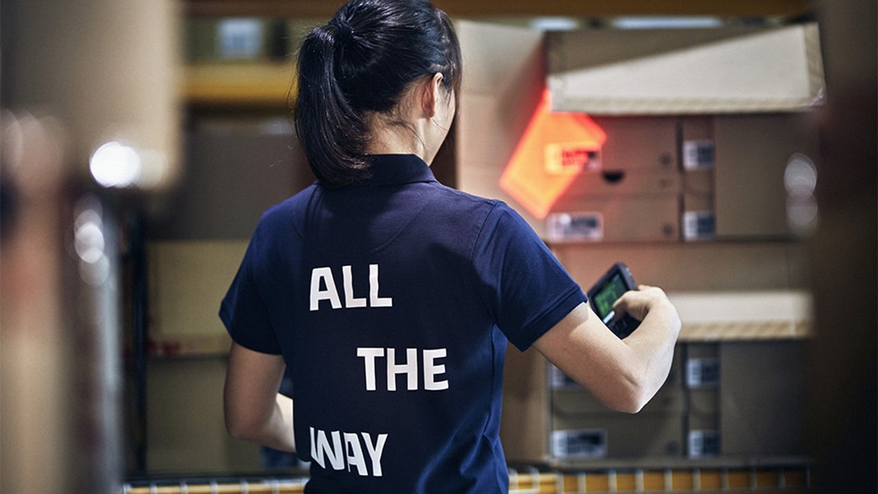 Female wearing a t-shirt with ALL THE WAY written on it