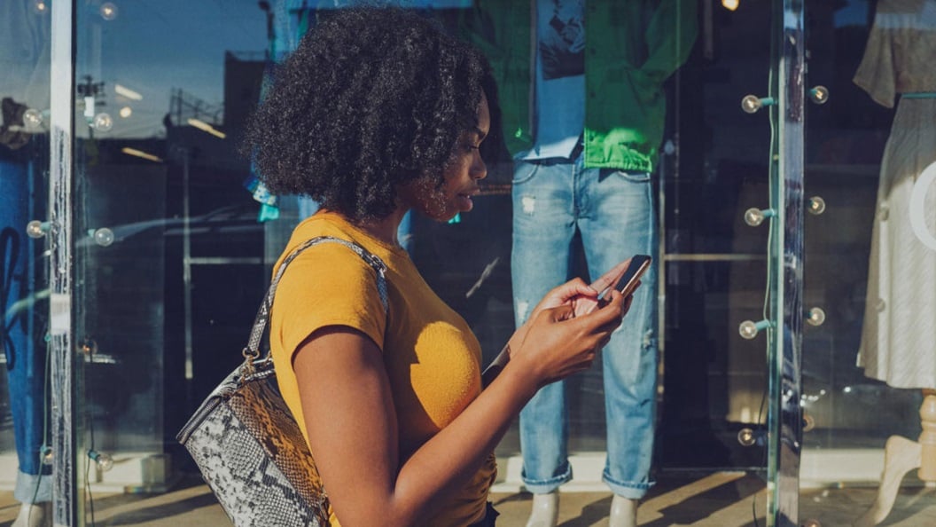 Woman with yellow t-shirt on her phone