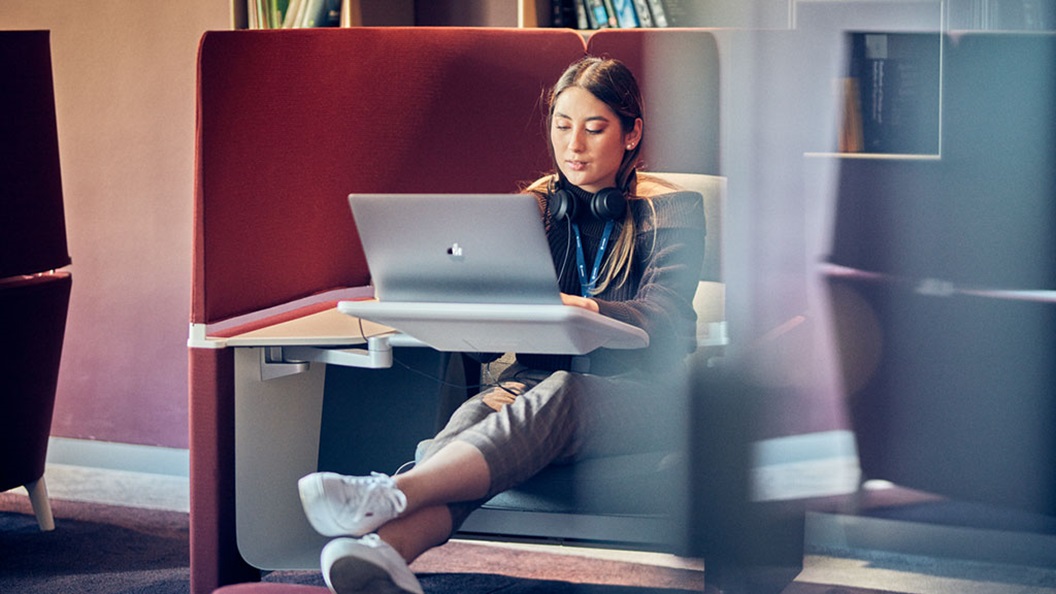 Woman sitting on a couch and working with her laptop