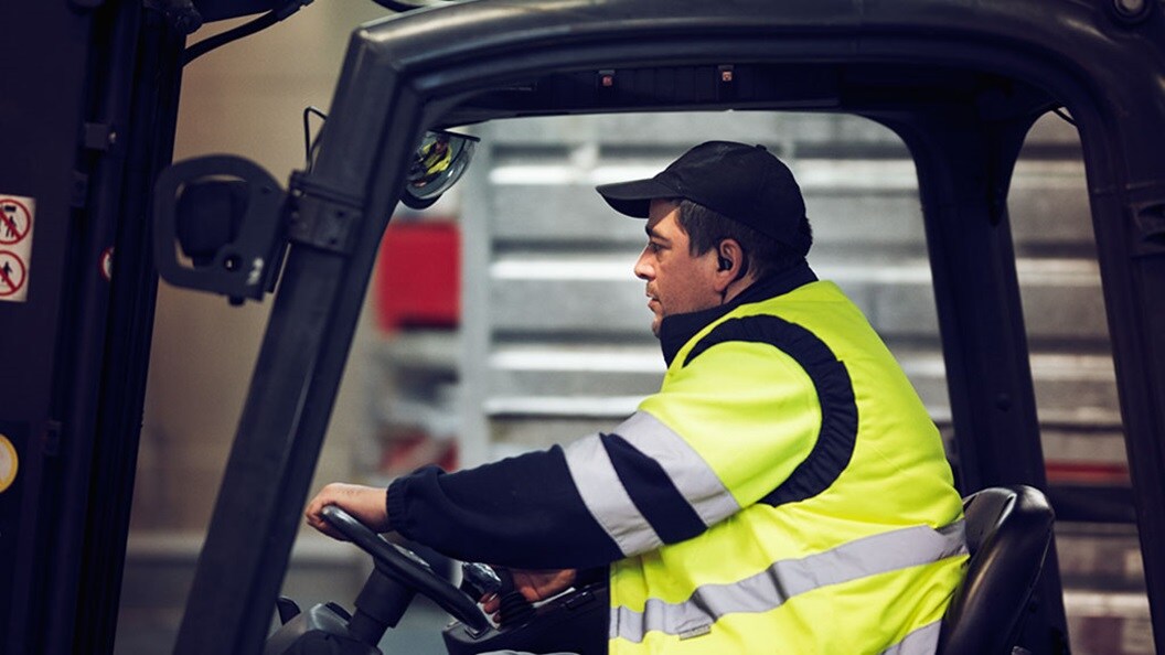 warehouse worker with yellow jacket moving items