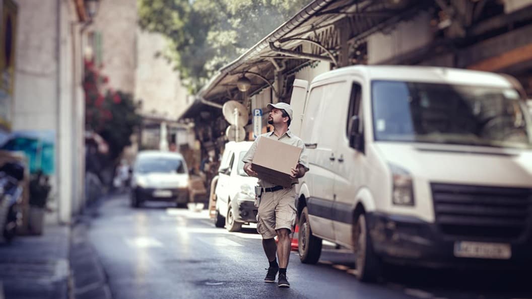 Stock engineer checking information with delivery woman.