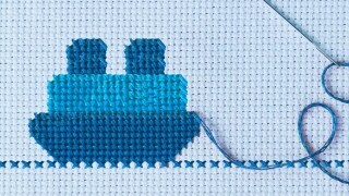 Close up shot of thread and a needle on a cloth