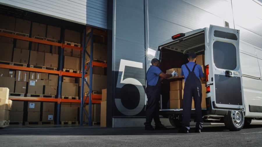 Two man arranging boxes.