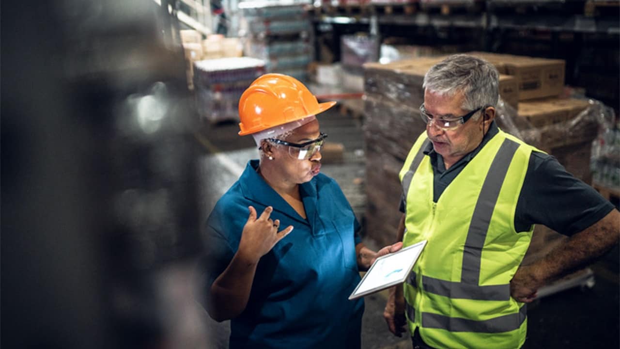 Two co-workers in a warehouse.