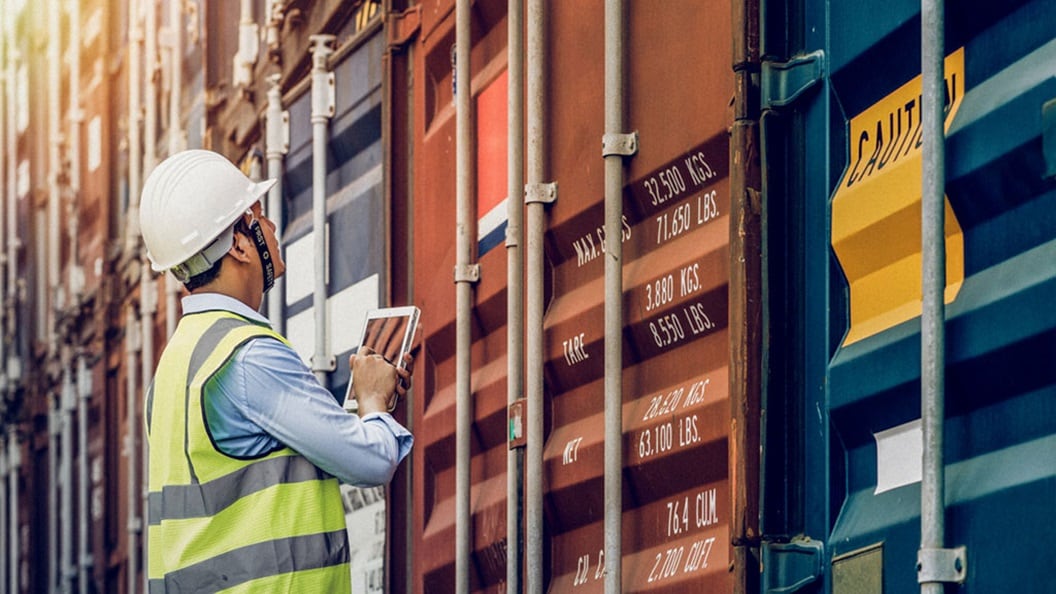Customs inspector checking export and import containers