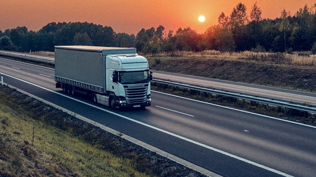 Truck on highway at sunset