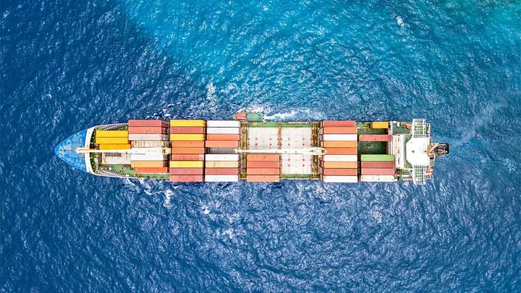 Cargo ship aerial photo – maritime shipping industry, ocean freight logistics, and global trade transportation.