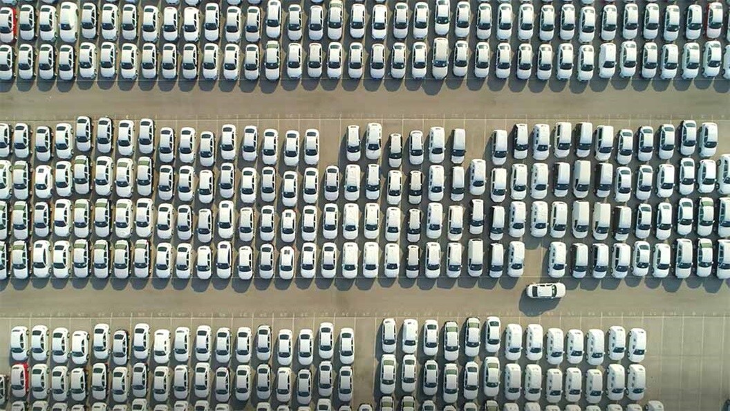 A line of blue electric cars charging.
