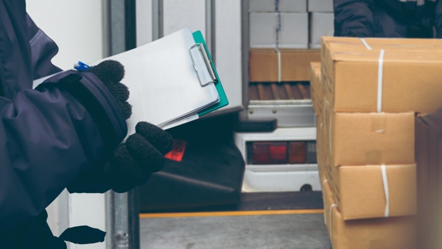 Hands signing off on the shipping log