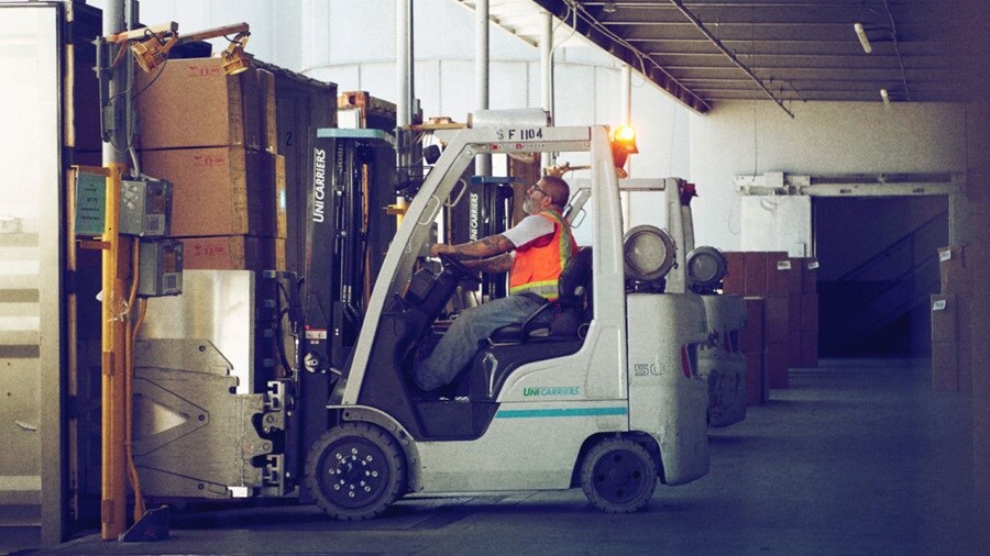 Person carrying load in warehouse