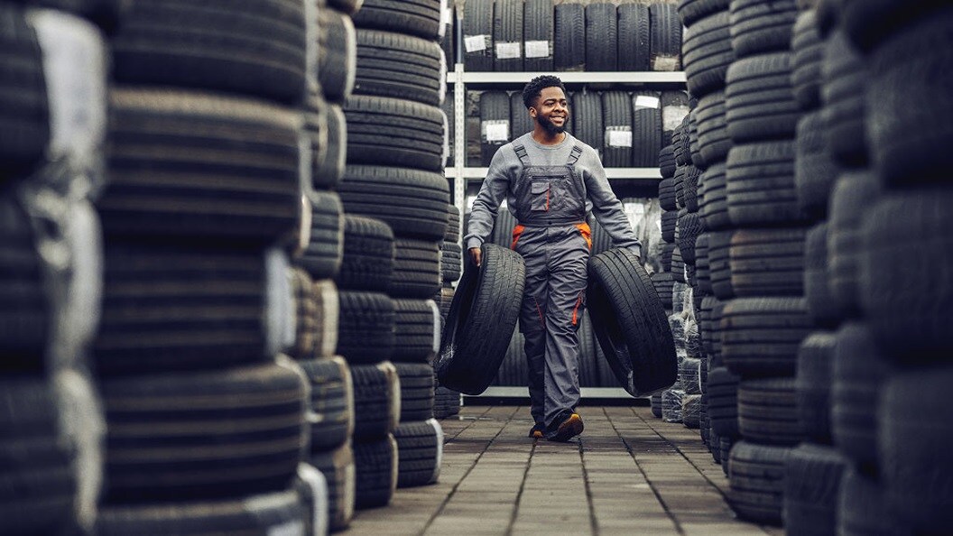 Man holding tyres