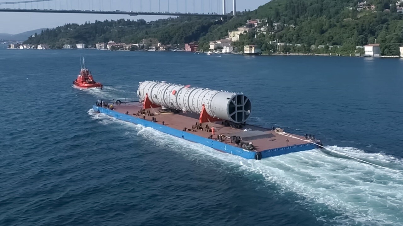 Tugboat towing a heavy cargo barge on the sea.