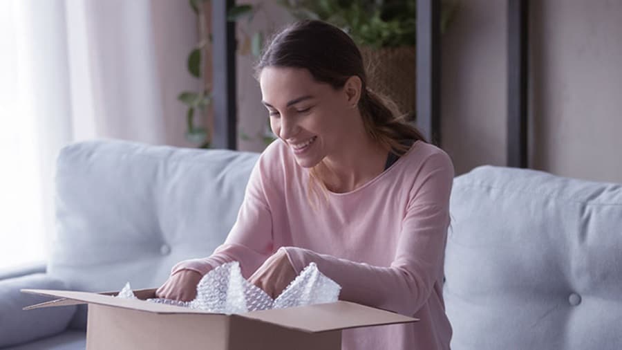 A happy woman opening the package