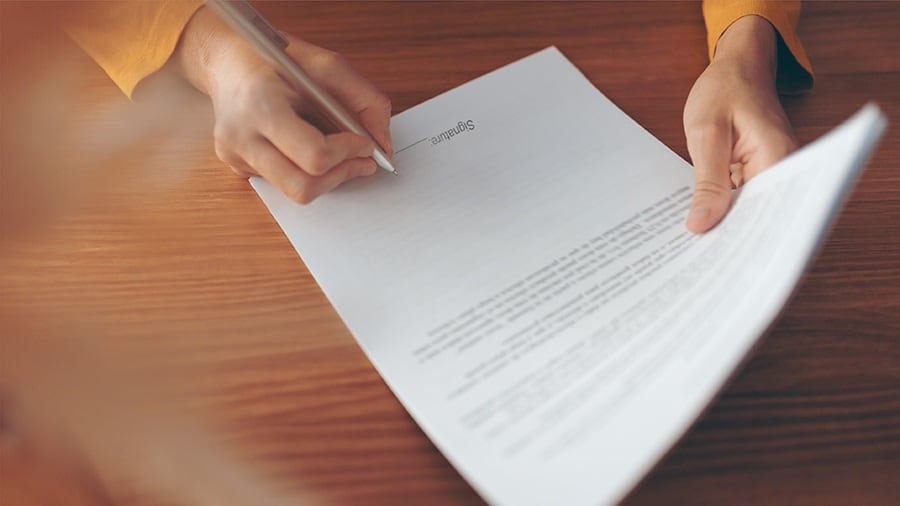 Woman signing a free trade agreements