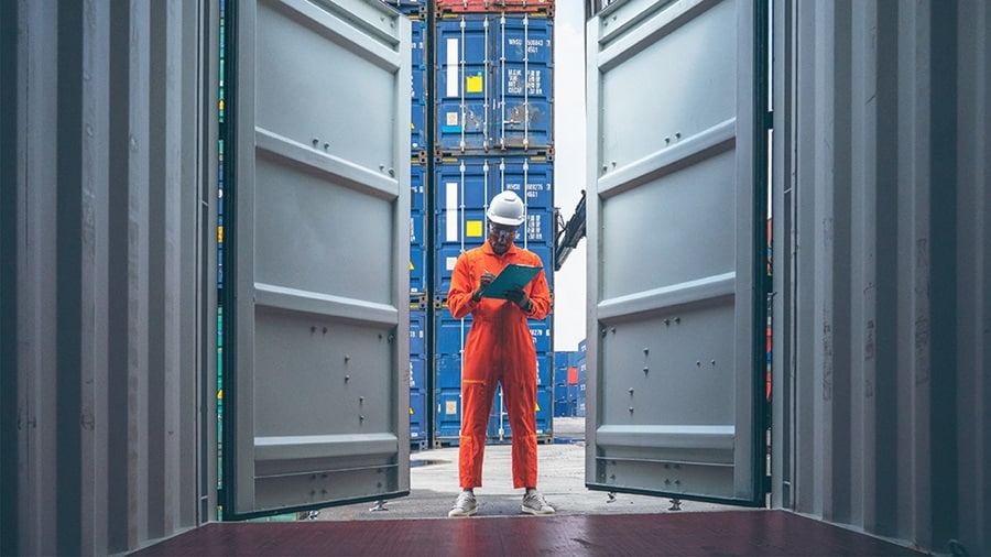 A man standing outside a container