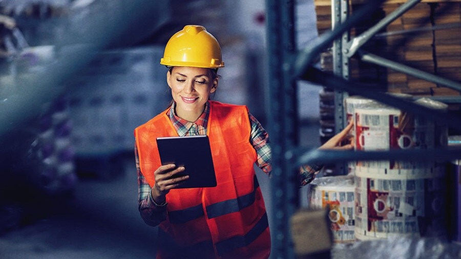Lady holding tab in warehouse