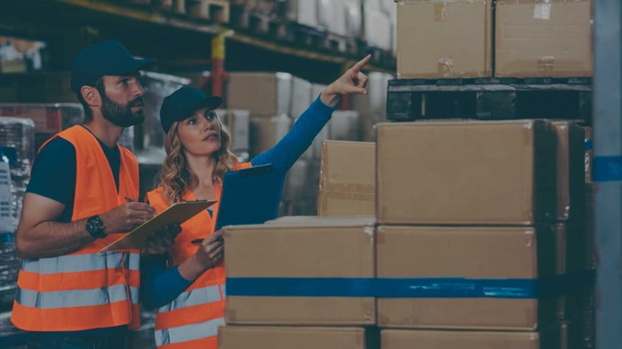 A male and a female working in the warehouse