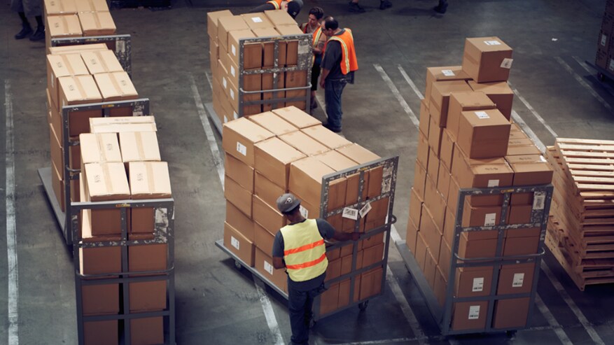 People working in a warehouse full of shipments