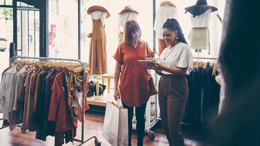 Two female conversing in a clothing stores