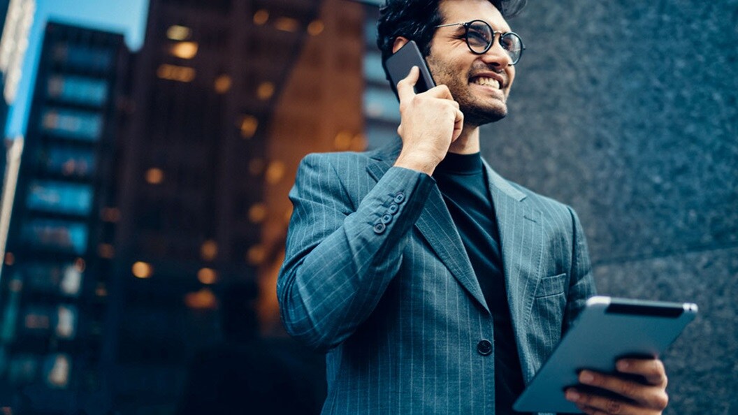 A smiling man on a phone 