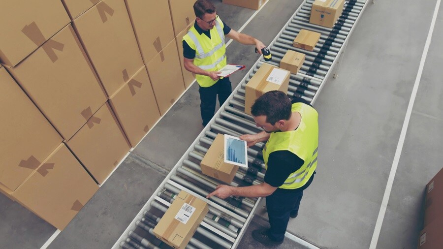 Two male working in a warehouse