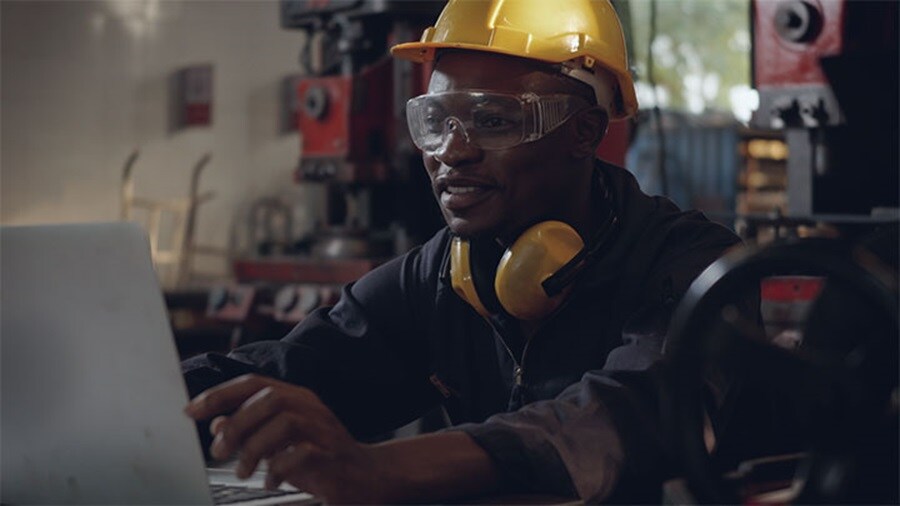 African technician working on laptop