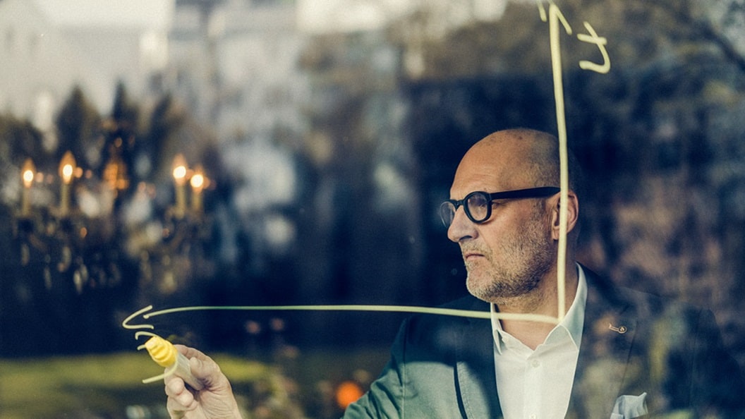 Man drawing graph on window