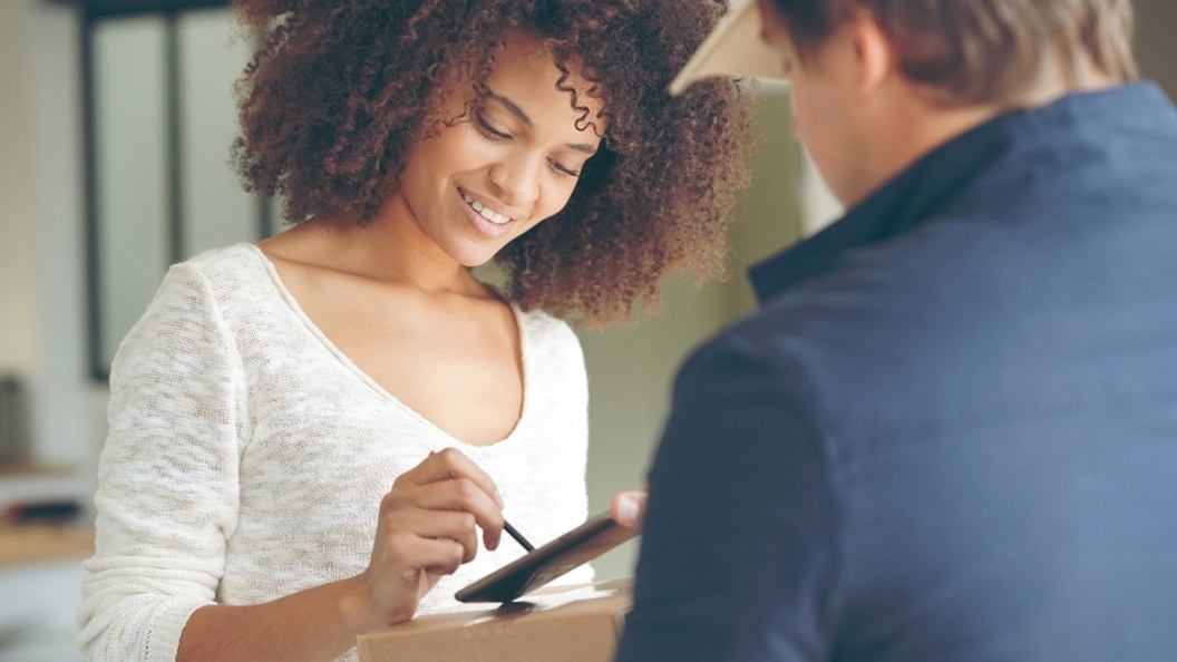 Woman accepting a delivery from the courier guy 