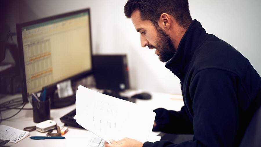 Customs officials inspecting cargo, highlighting new ICS2 regulations.