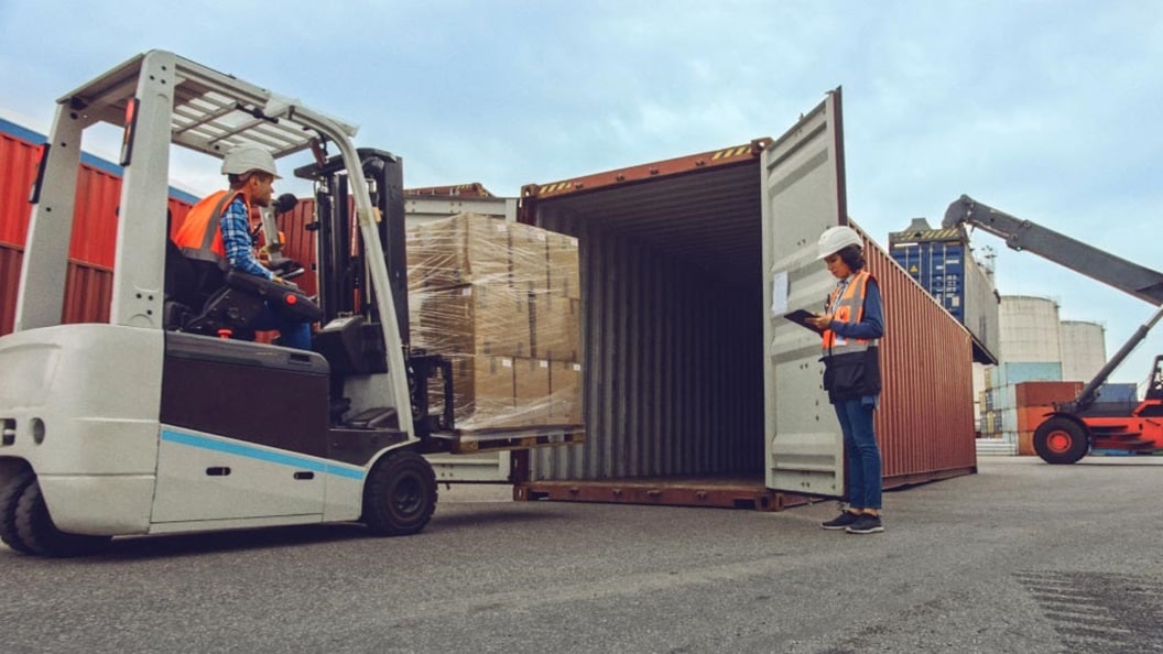 Man in crane woman holding laptop