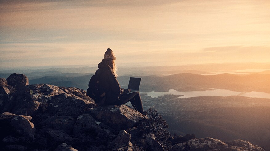 Woman working from hill top