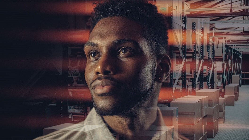 A thoughtful man’s face is superimposed over a modern warehouse filled with shelves and stacked boxes, symbolizing logistics, supply chain innovation, and market insights.