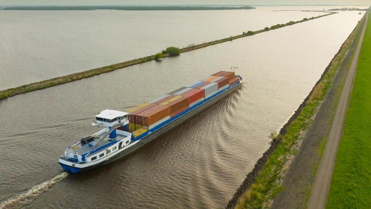 Cargo ship sailing on river canal