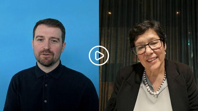 Two individuals pose together, all smiling in a casual setting.