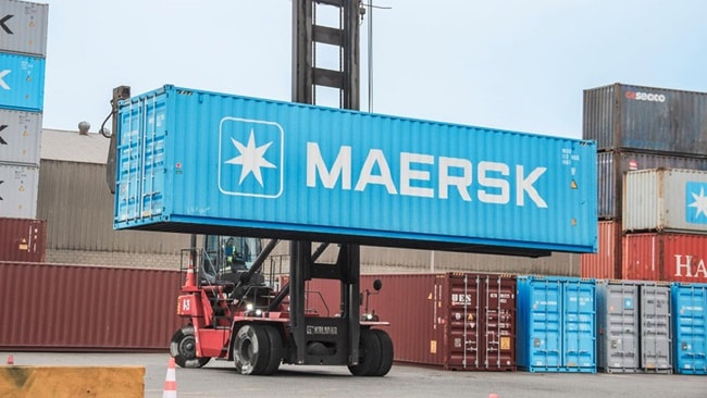 Maersk blue container lifted by a crane at a port