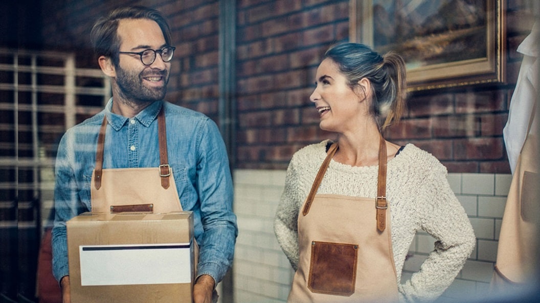 Two customers holding cardboard boxes