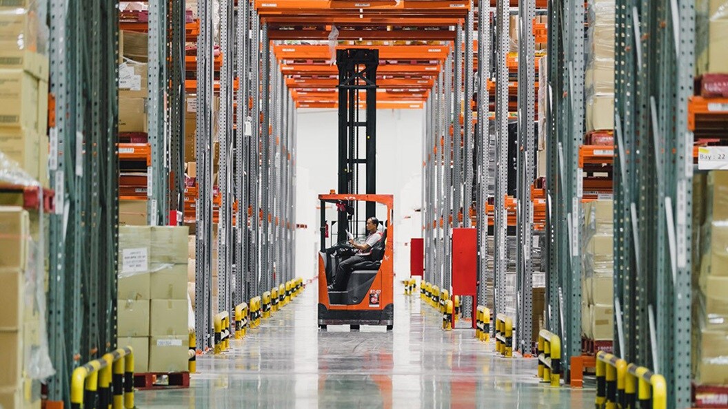 Maersk employee lifting cargo in warehouse
